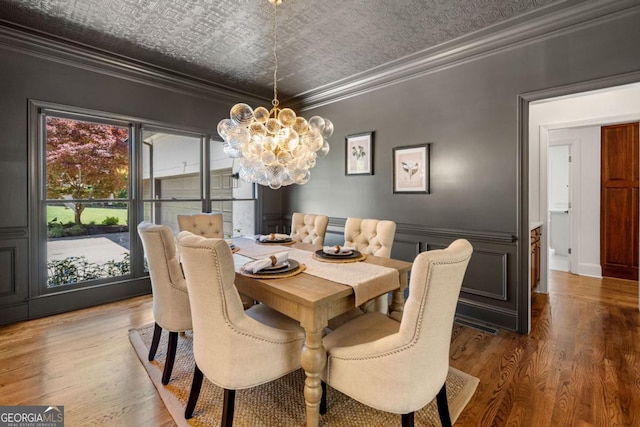 414 Dogwood Way, Canton, GA 30114 - dining area with an ornate ceiling, ornamental molding, a chandelier, wood finished floors, and wainscoting