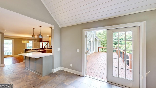 1477 Triple Creek Ct NW, Kennesaw, GA 30144 - kitchen with a peninsula, baseboards, decorative light fixtures, lofted ceiling, and light countertops