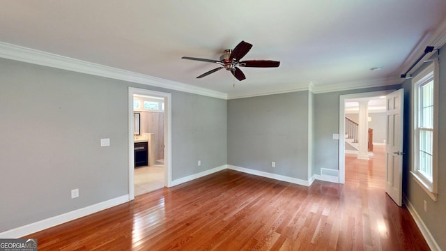 1477 Triple Creek Ct NW, Kennesaw, GA 30144 - spare room with plenty of natural light, stairway, a fireplace, wood finished floors, and crown molding