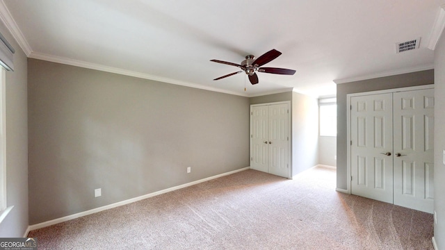1477 Triple Creek Ct NW, Kennesaw, GA 30144 - unfurnished bedroom with two closets, light carpet, ornamental molding, baseboards, and a ceiling fan