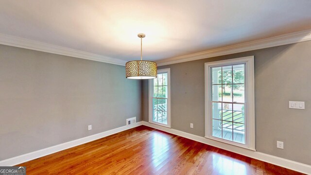 1477 Triple Creek Ct NW, Kennesaw, GA 30144 - spare room featuring wood finished floors, baseboards, and crown molding