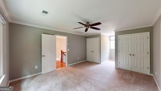 1477 Triple Creek Ct NW, Kennesaw, GA 30144 - unfurnished bedroom with light carpet, two closets, crown molding, baseboards, and ceiling fan