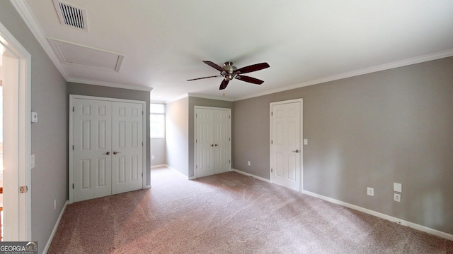 1477 Triple Creek Ct NW, Kennesaw, GA 30144 - unfurnished bedroom featuring carpet, multiple closets, baseboards, crown molding, and attic access