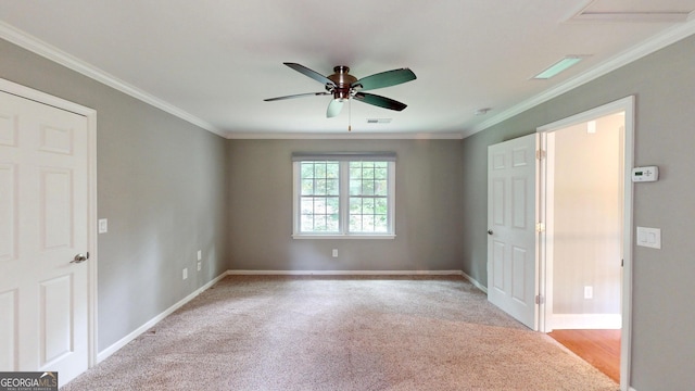 1477 Triple Creek Ct NW, Kennesaw, GA 30144 - spare room with ceiling fan, baseboards, light carpet, and crown molding