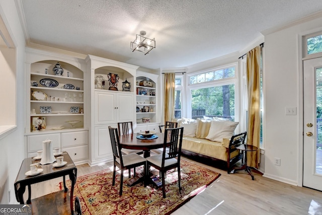 248 Riverview Trl, Roswell, GA 30075 - dining area with a textured ceiling, crown molding, light wood finished floors, and built in features