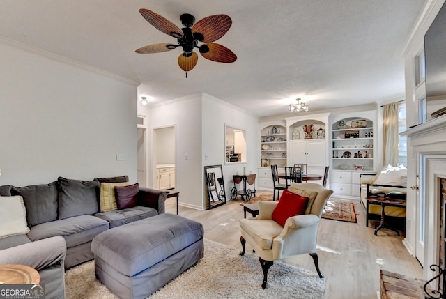 248 Riverview Trl, Roswell, GA 30075 - living area with light wood-style floors, ornamental molding, a ceiling fan, built in shelves, and a fireplace