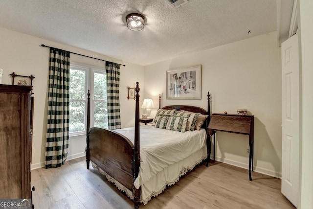 248 Riverview Trl, Roswell, GA 30075 - bedroom with light wood-type flooring, a textured ceiling, and baseboards