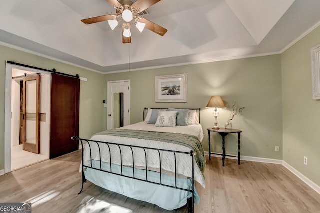 248 Riverview Trl, Roswell, GA 30075 - bedroom featuring lofted ceiling, a barn door, light wood-type flooring, baseboards, and a tray ceiling