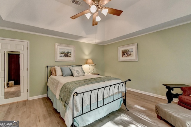 248 Riverview Trl, Roswell, GA 30075 - bedroom featuring wood finished floors, ornamental molding, a ceiling fan, and a tray ceiling