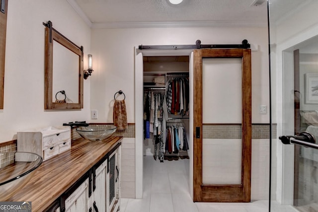 248 Riverview Trl, Roswell, GA 30075 - full bath featuring vanity, ornamental molding, a walk in closet, and tile patterned flooring