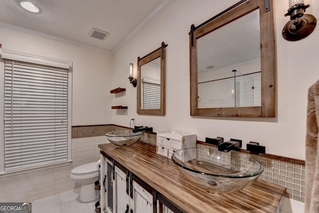248 Riverview Trl, Roswell, GA 30075 - bathroom with tile walls, crown molding, toilet, double vanity, and tile patterned flooring