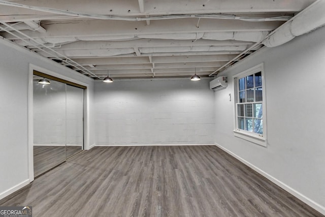 248 Riverview Trl, Roswell, GA 30075 - below grade area featuring a wall mounted AC, wood finished floors, and baseboards