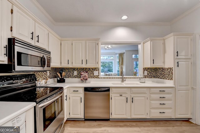 248 Riverview Trl, Roswell, GA 30075 - kitchen with appliances with stainless steel finishes, a sink, crown molding, light countertops, and backsplash
