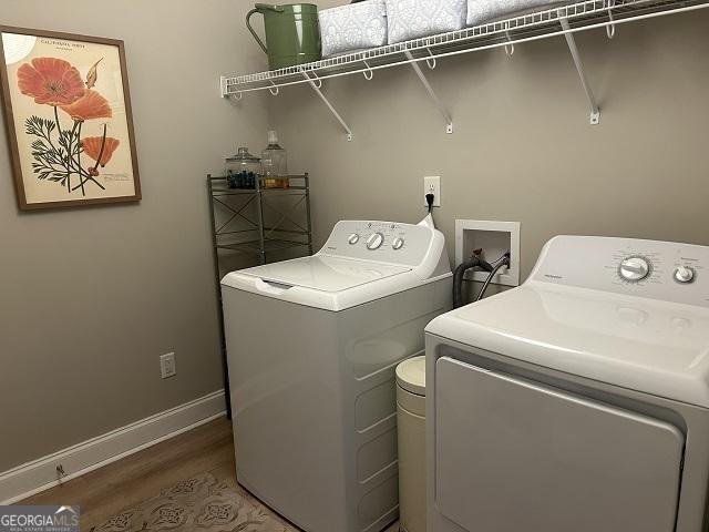 109 Berkley Cir, Warner Robins, GA 31093 - washroom featuring independent washer and dryer, wood finished floors, and baseboards