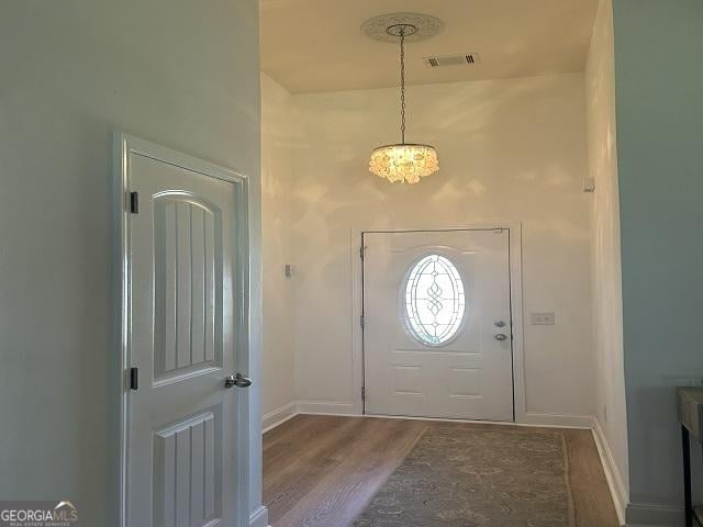 109 Berkley Cir, Warner Robins, GA 31093 - foyer with wood finished floors, a chandelier, and baseboards