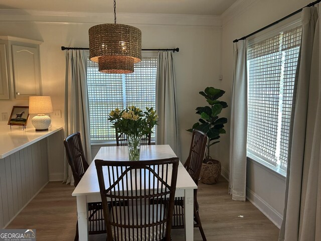 109 Berkley Cir, Warner Robins, GA 31093 - dining space featuring light wood-type flooring, a chandelier, baseboards, and crown molding