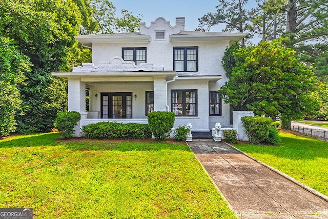 209 Forest Hill Rd, Macon, GA 31210 - view of front facade with a porch, brick siding, a front lawn, and french doors