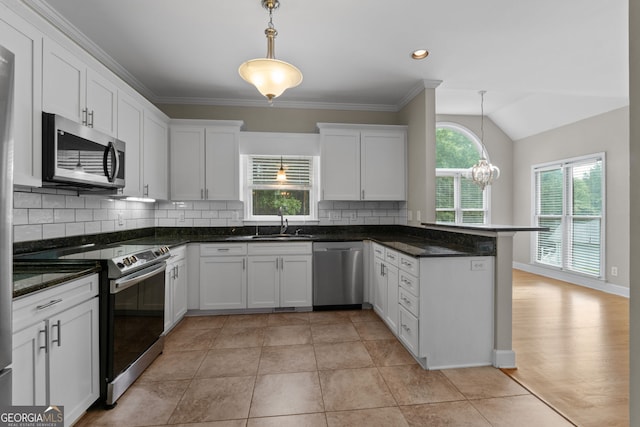 3642 Fowler Rdg, Douglasville, GA 30135 - kitchen featuring appliances with stainless steel finishes, a sink, white cabinetry, a peninsula, and tasteful backsplash