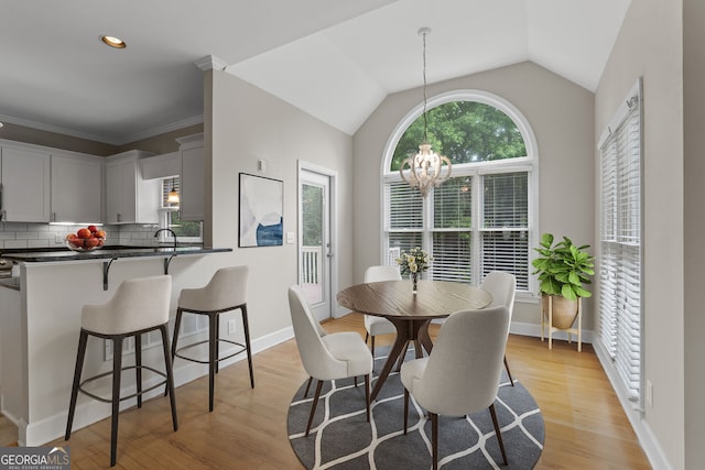 3642 Fowler Rdg, Douglasville, GA 30135 - dining space featuring a chandelier, light wood finished floors, vaulted ceiling, baseboards, and recessed lighting