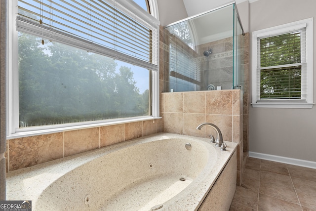 3642 Fowler Rdg, Douglasville, GA 30135 - full bath with plenty of natural light, a jetted tub, a tile shower, and baseboards