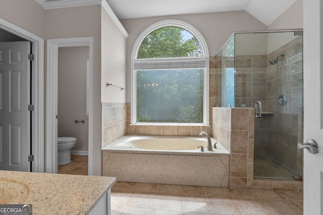 3642 Fowler Rdg, Douglasville, GA 30135 - bathroom featuring a bath, a shower stall, tile patterned flooring, toilet, and vaulted ceiling