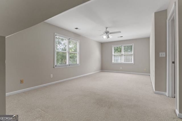 3642 Fowler Rdg, Douglasville, GA 30135 - spare room featuring baseboards, a ceiling fan, plenty of natural light, and light carpet