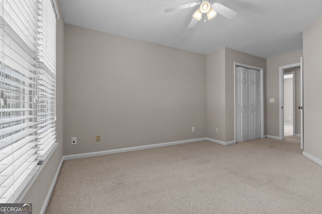 3642 Fowler Rdg, Douglasville, GA 30135 - unfurnished bedroom featuring light colored carpet, baseboards, a ceiling fan, and a closet