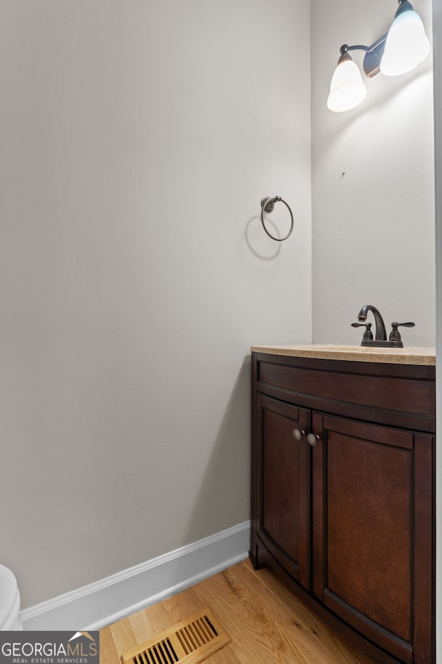 3642 Fowler Rdg, Douglasville, GA 30135 - bathroom with vanity, toilet, wood finished floors, and baseboards