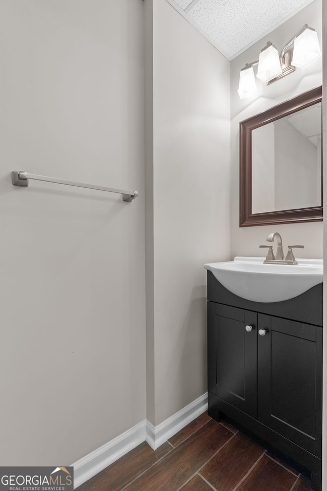 3642 Fowler Rdg, Douglasville, GA 30135 - bathroom featuring wood finished floors, vanity, and baseboards