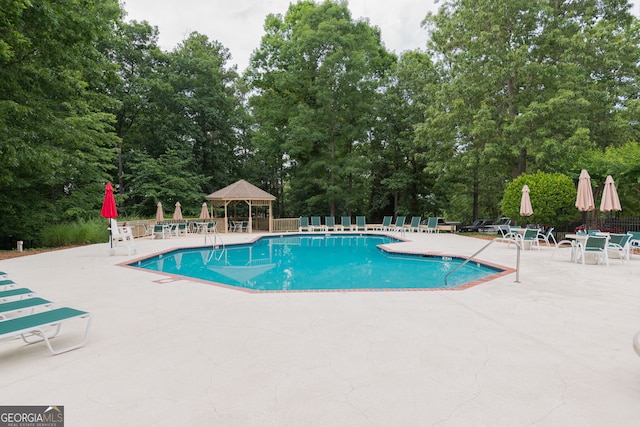 3642 Fowler Rdg, Douglasville, GA 30135 - community pool with a gazebo, a patio area, and view of wooded area