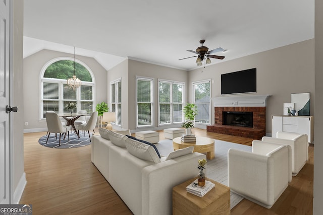 3642 Fowler Rdg, Douglasville, GA 30135 - living room with light wood-style floors, ceiling fan, healthy amount of natural light, a brick fireplace, and vaulted ceiling