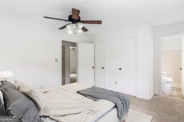 320 Edna Dr, Stockbridge, GA 30281 - bedroom featuring light carpet, connected bathroom, ceiling fan, and baseboards