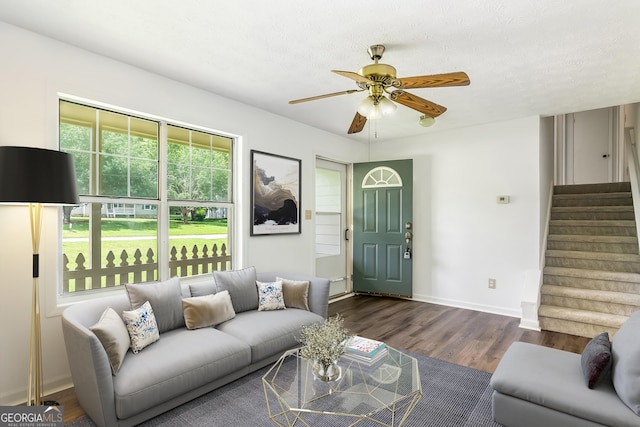 320 Edna Dr, Stockbridge, GA 30281 - living room with stairs, a ceiling fan, dark wood-style floors, and baseboards