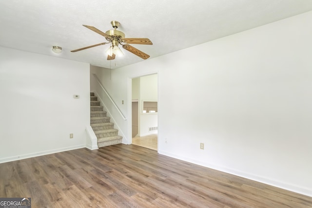 320 Edna Dr, Stockbridge, GA 30281 - unfurnished room with wood finished floors, stairway, ceiling fan, and baseboards
