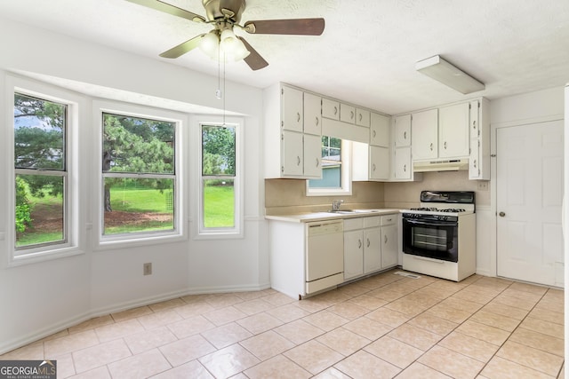 320 Edna Dr, Stockbridge, GA 30281 - kitchen featuring gas range oven, under cabinet range hood, white dishwasher, light countertops, and a sink