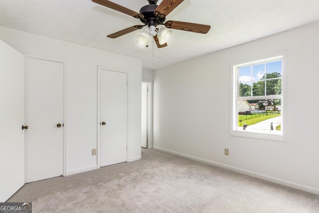 320 Edna Dr, Stockbridge, GA 30281 - unfurnished bedroom featuring light colored carpet, baseboards, and a ceiling fan