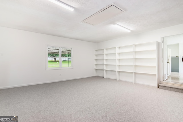 320 Edna Dr, Stockbridge, GA 30281 - carpeted spare room with attic access and baseboards