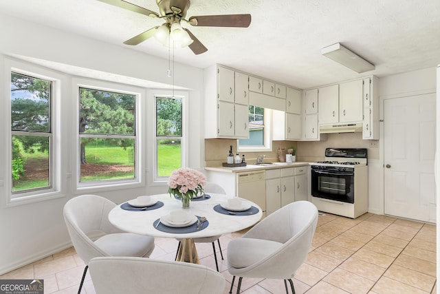 320 Edna Dr, Stockbridge, GA 30281 - kitchen with gas stove, under cabinet range hood, dishwasher, light countertops, and a sink