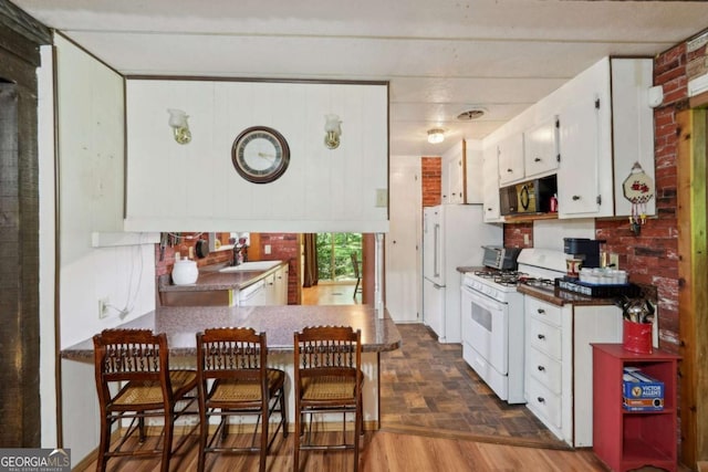 293 Timber Ridge Dr, Athens, GA 30607 - kitchen with white appliances, a sink, white cabinets, and dark countertops