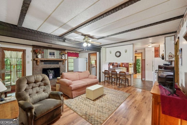 293 Timber Ridge Dr, Athens, GA 30607 - living area featuring plenty of natural light, light wood finished floors, a brick fireplace, and beamed ceiling