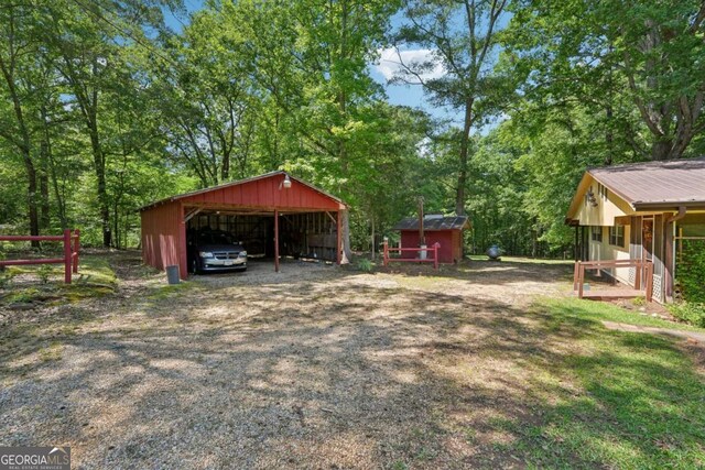 293 Timber Ridge Dr, Athens, GA 30607 - view of yard featuring an outdoor structure, a detached carport, and an outbuilding