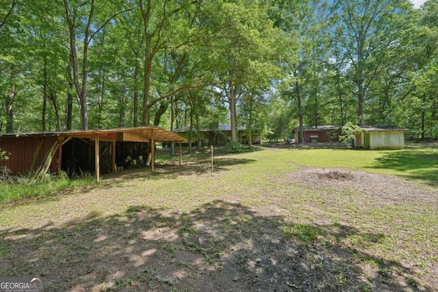 293 Timber Ridge Dr, Athens, GA 30607 - view of green lawn featuring an outdoor structure and a detached carport