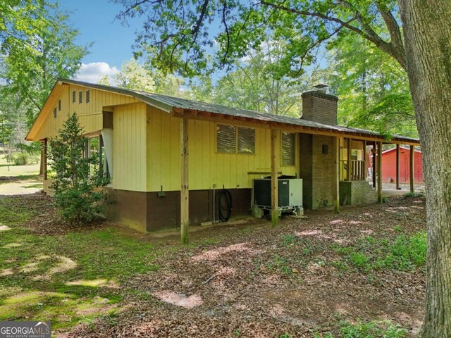 293 Timber Ridge Dr, Athens, GA 30607 - rear view of house with a chimney and central AC unit