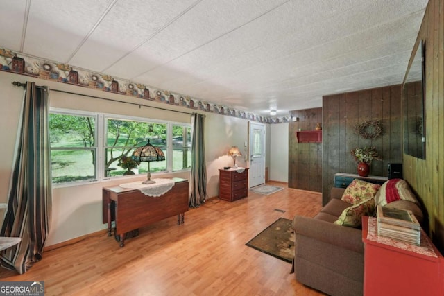 293 Timber Ridge Dr, Athens, GA 30607 - living area with wooden walls, wood finished floors, and baseboards