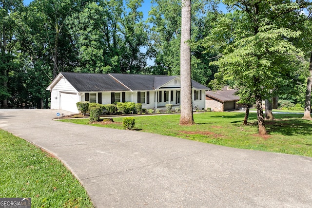 3210 Roseheath Ln, Lithonia, GA 30038 - ranch-style home with a front lawn, a garage, driveway, and brick siding
