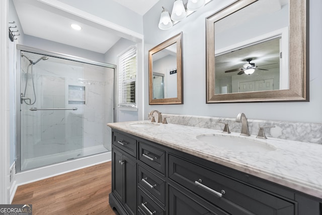 3210 Roseheath Ln, Lithonia, GA 30038 - bathroom featuring double vanity, a marble finish shower, wood finished floors, and a ceiling fan