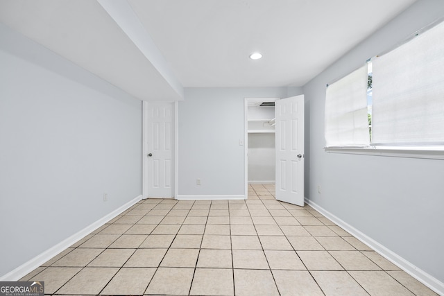 3210 Roseheath Ln, Lithonia, GA 30038 - unfurnished bedroom featuring baseboards, light tile patterned flooring, recessed lighting, a spacious closet, and a closet
