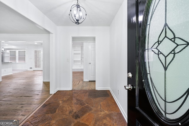 3210 Roseheath Ln, Lithonia, GA 30038 - entryway featuring a chandelier, baseboards, and stone finish flooring