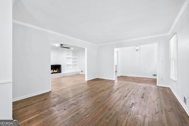 3210 Roseheath Ln, Lithonia, GA 30038 - unfurnished living room with wood finished floors, a brick fireplace, built in shelves, ornamental molding, and baseboards