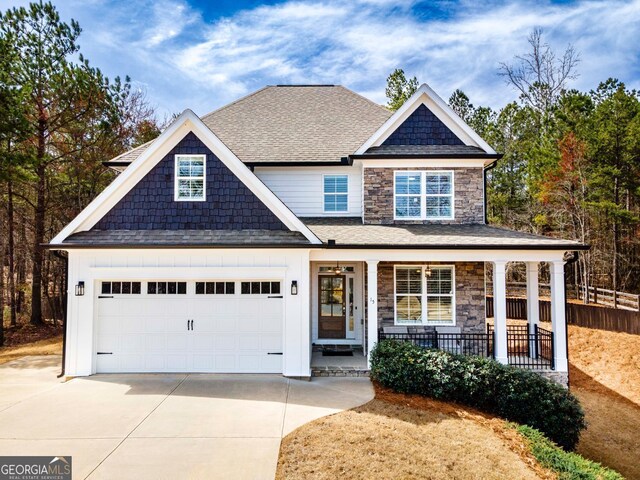 15 Jamilee Cv, Cartersville, GA 30120 - view of front of house featuring covered porch, driveway, stone siding, and a garage